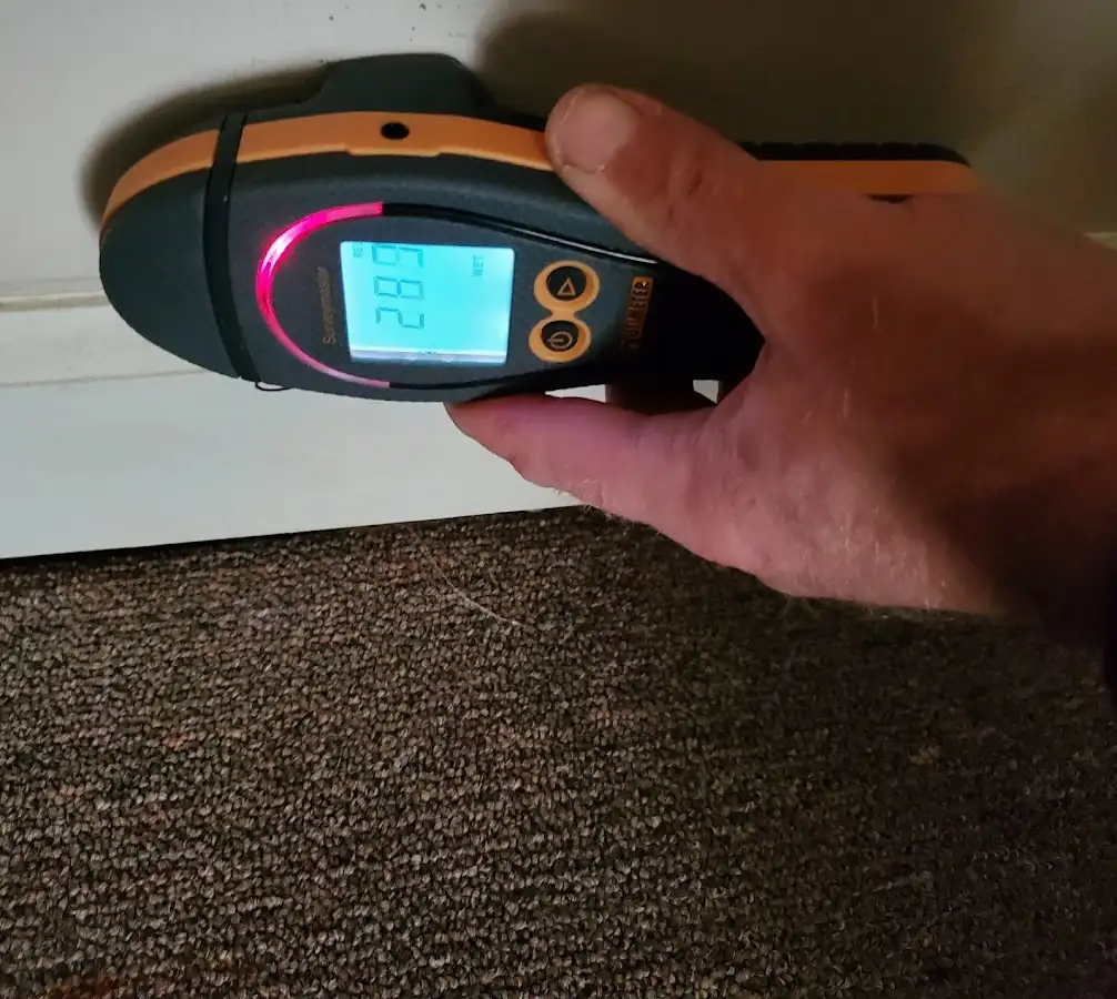 Moisture detection at baseboard during Storm Damage Restoration in Texas